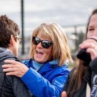 Kim Schmidt laughs and hugs a friend